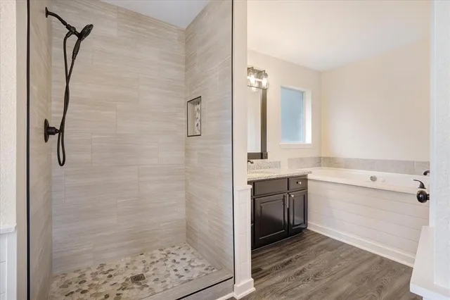 a bathroom with a shower sink and mirror