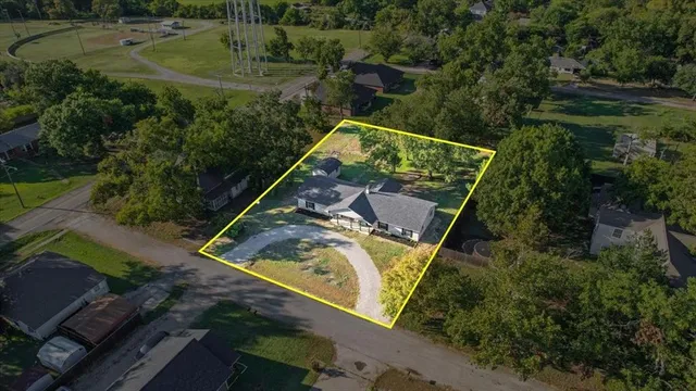 an aerial view of a house with a yard basket ball court and outdoor seating