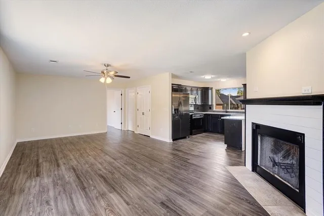 a view of kitchen with wooden floor and a fireplace