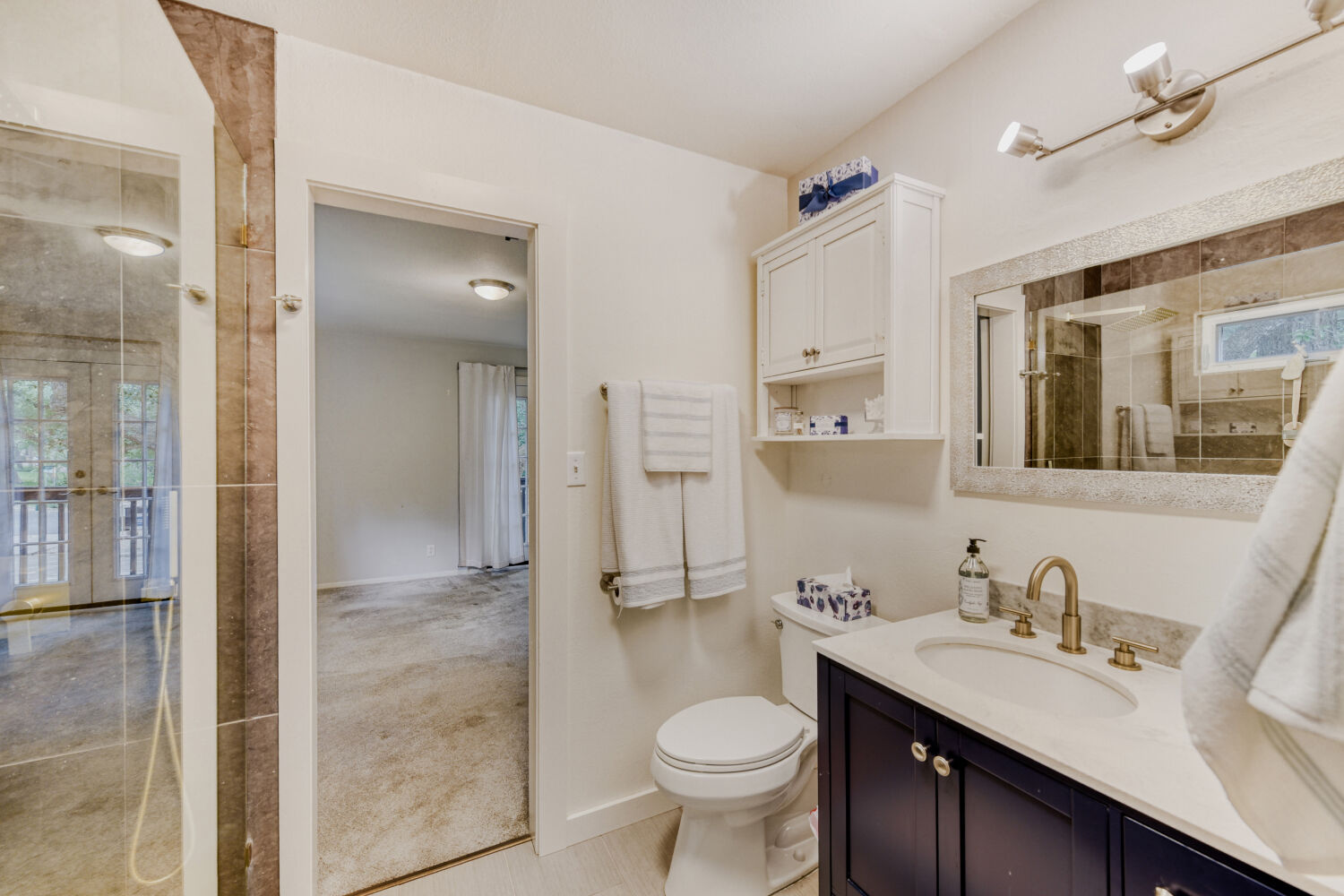 1912 Lightsey Road, Unit 6 Austin, TX 78704 - Photo 19 of 27 a bathroom with a sink toilet a mirror and shower