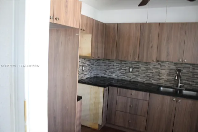 a kitchen with a sink and cabinets