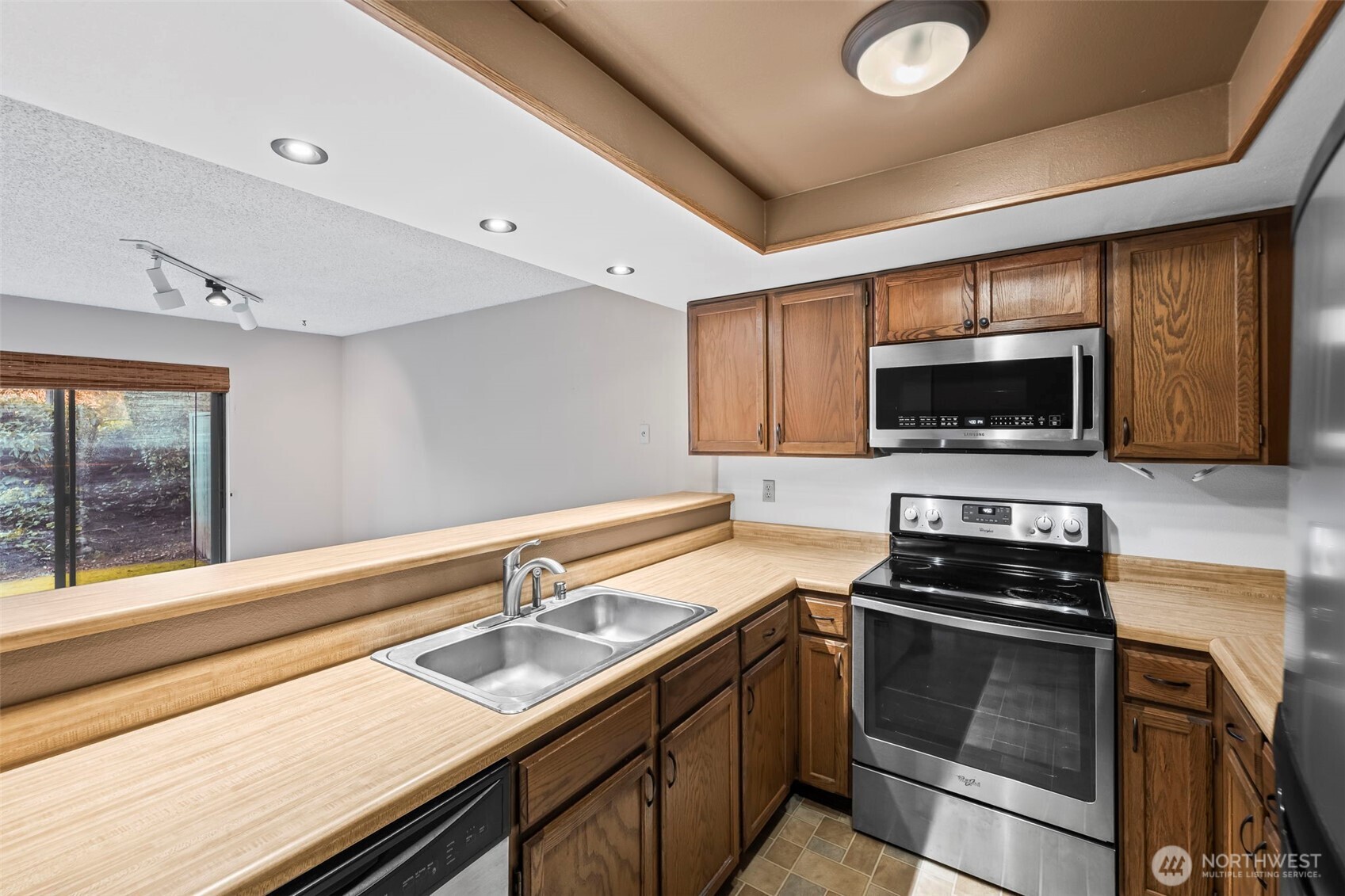 31727 47th Lane Southwest, Unit C Federal Way, WA 98023 - Photo 11 of 39 a kitchen with a sink stainless steel appliances and cabinets