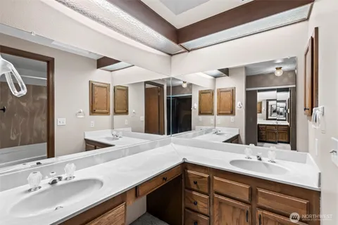 a bathroom with a sink double vanity and a mirror