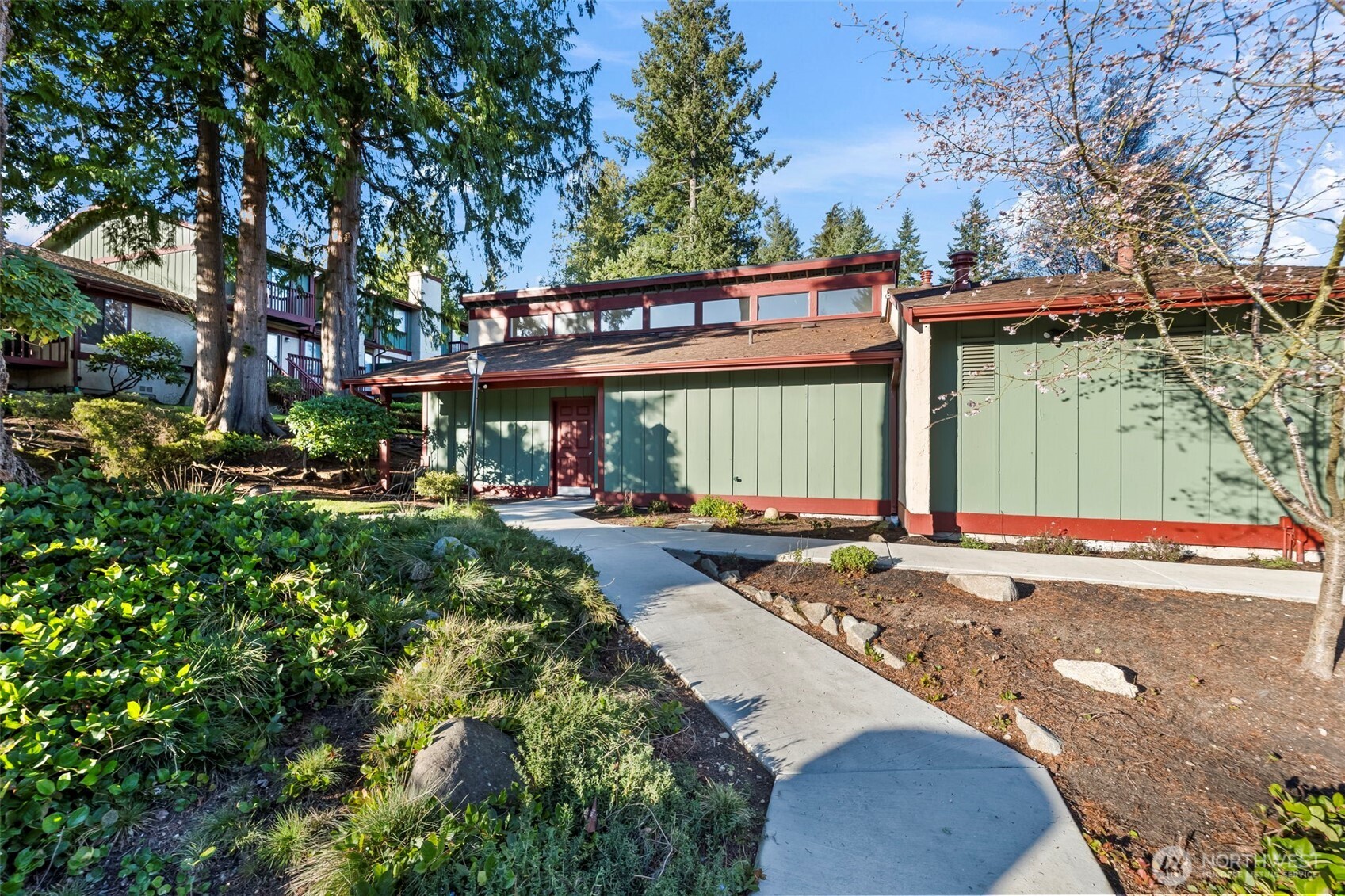 31727 47th Lane Southwest, Unit C Federal Way, WA 98023 - Photo 27 of 39 a view of a white house with a large tree and flower plants