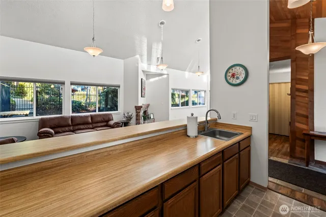 a kitchen with stainless steel appliances a sink and a large window