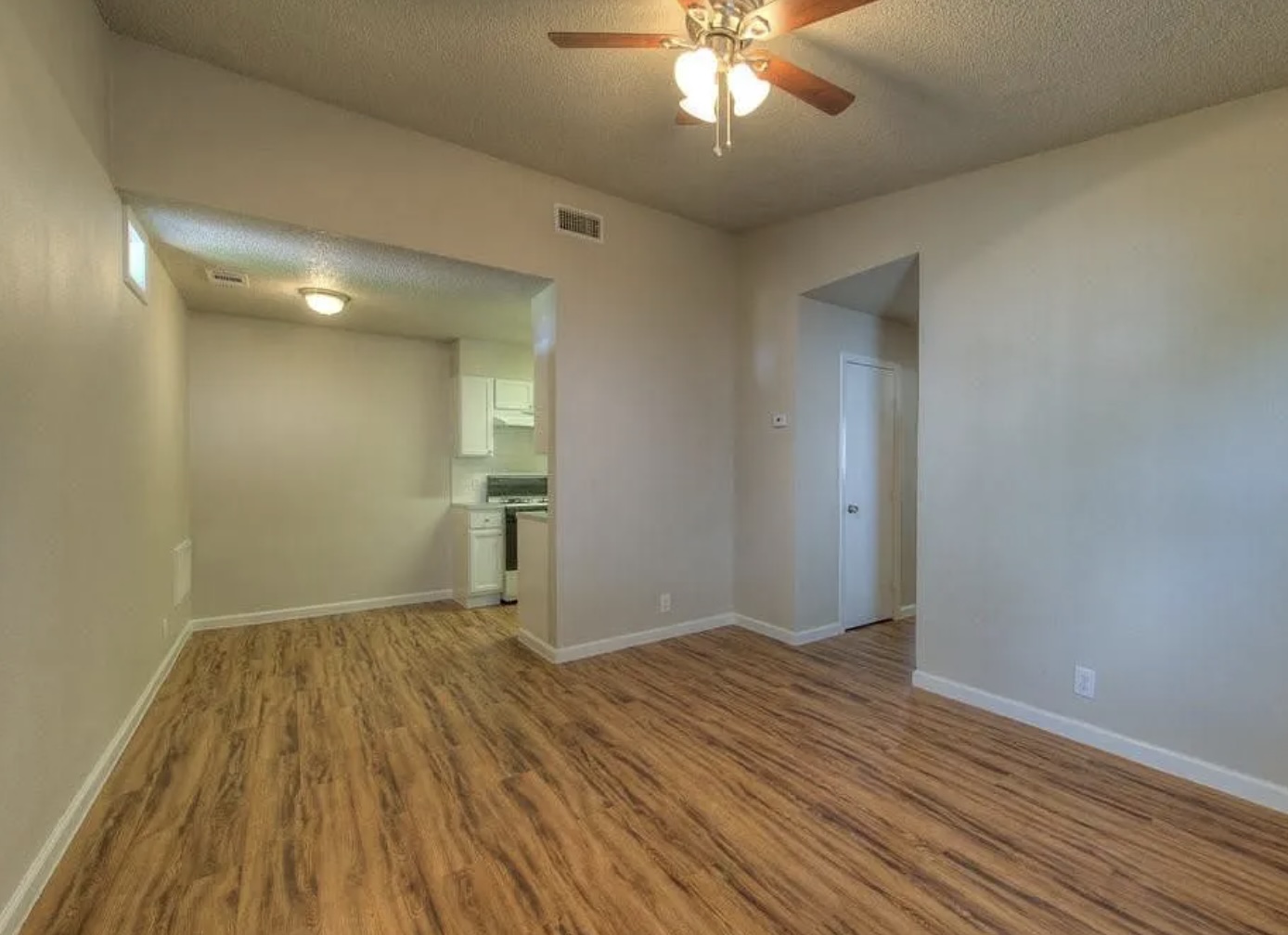 1124 Gardner Road, Unit B Austin, TX 78721 - Photo 6 of 15 Spare room featuring a textured ceiling, light wood-style flooring, and a ceiling fan