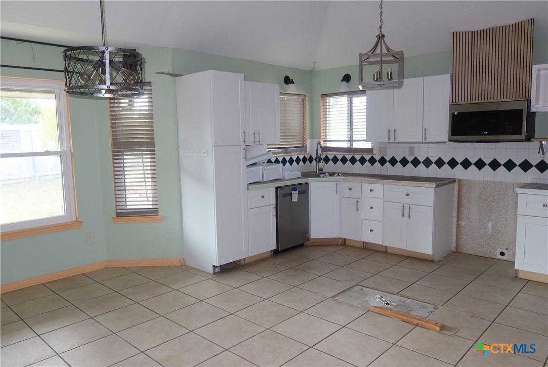 5101 Spring Drive Killeen, TX 76542 - Photo 4 of 11 a kitchen with stainless steel appliances granite countertop a stove a sink and a refrigerator