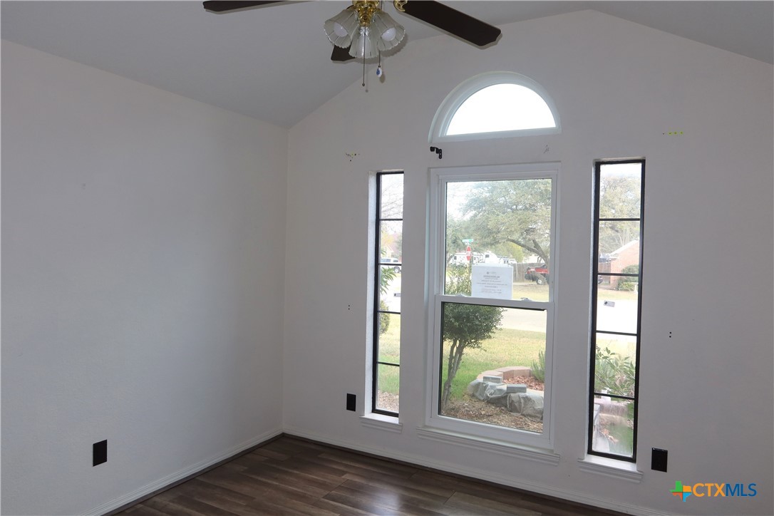 5101 Spring Drive Killeen, TX 76542 - Photo 9 of 11 an empty room with wooden floor fan and windows