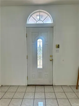 a view of a hallway to a livingroom with windows