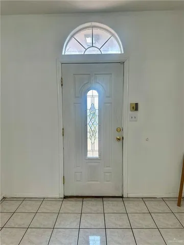 a view of a hallway to a livingroom with windows