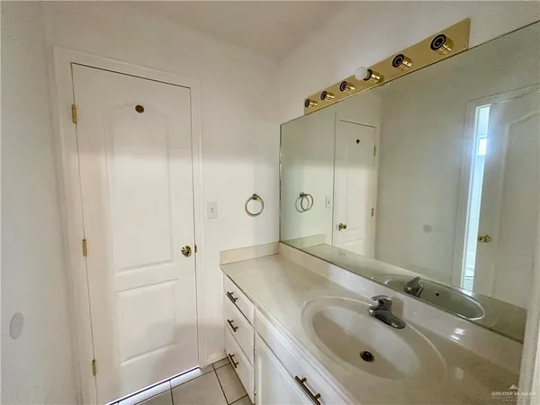 a bathroom with a shower sink and mirror