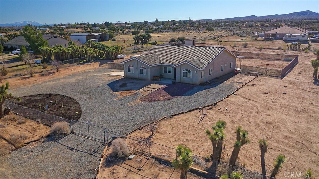 an aerial view of a house with a mountain