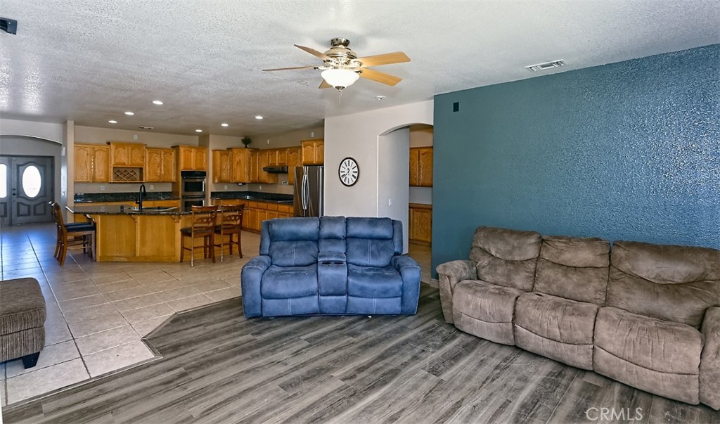 8855 Smith Road Phelan, CA 92371 - Photo 14 of 43 a living room with furniture kitchen view and a chandelier