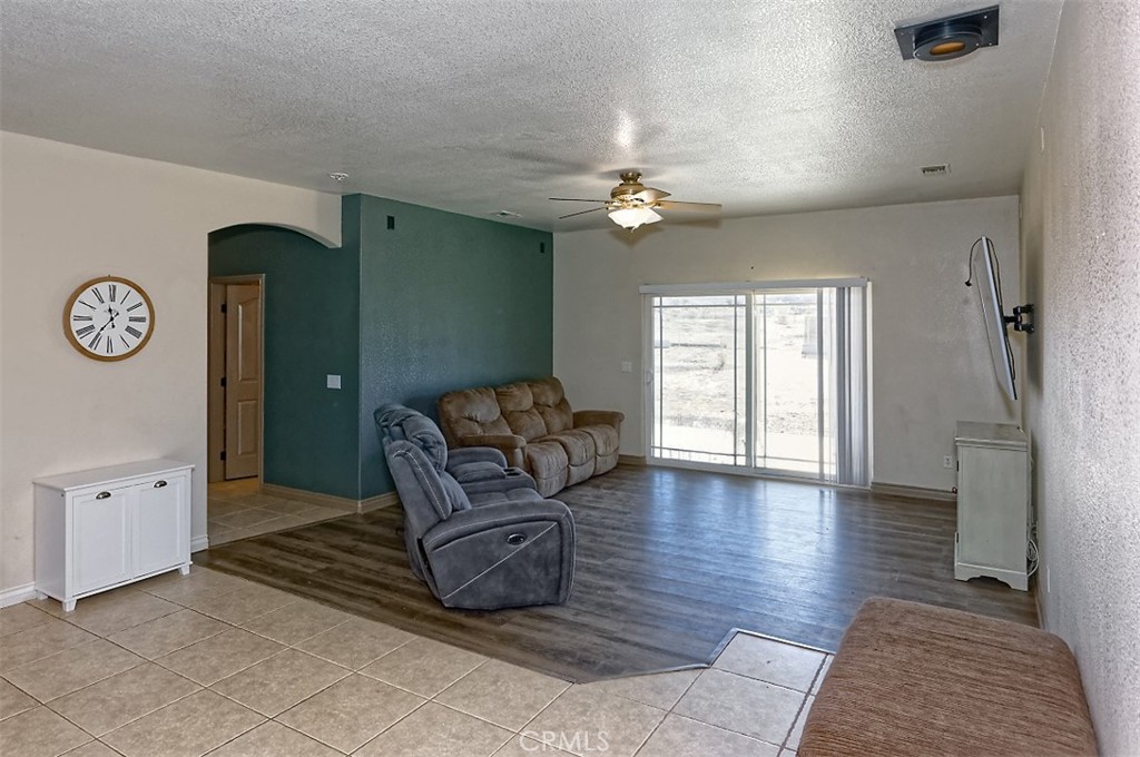 8855 Smith Road Phelan, CA 92371 - Photo 16 of 43 a living room with furniture a chandelier and a window