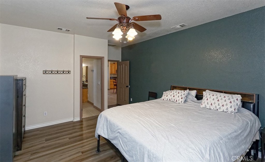 8855 Smith Road Phelan, CA 92371 - Photo 27 of 43 a bedroom with a bed and a chandelier