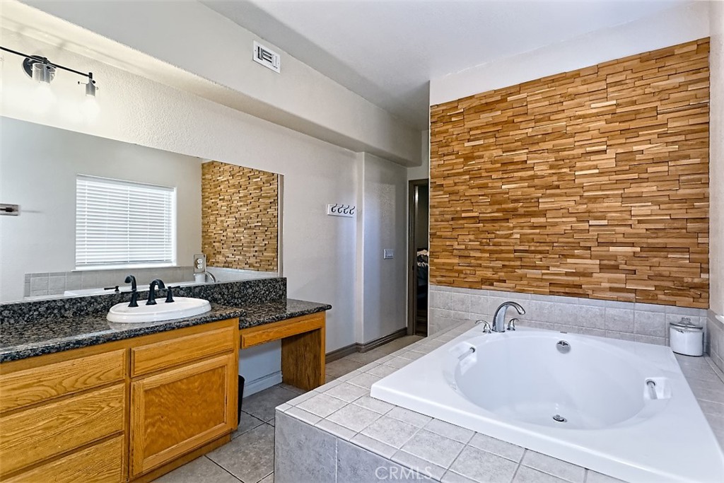 8855 Smith Road Phelan, CA 92371 - Photo 30 of 43 a bathroom with a tub sink and mirror