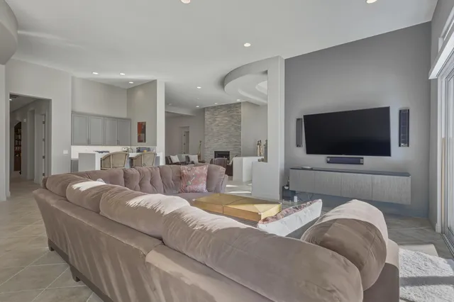 a kitchen with kitchen island granite countertop a sink cabinets and stainless steel appliances