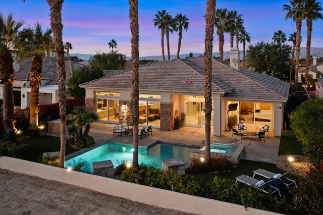 a view of a house with yard and sitting area