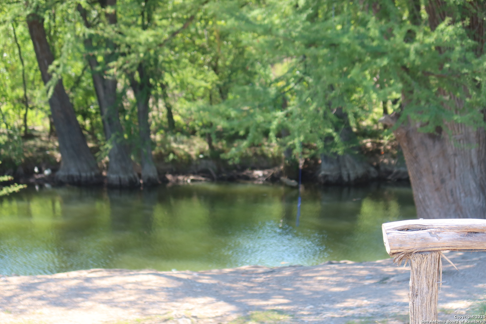 Tbd Lot 1 Pecan Bandera, TX 78003 - Photo 11 of 17 a view of a lake with a yard and trees