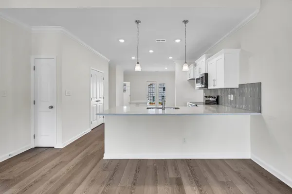 a view of kitchen with sink and wooden floor