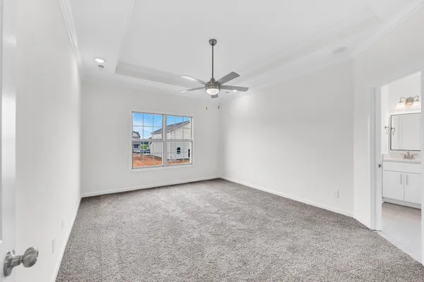 a view of a room with a ceiling fan and window