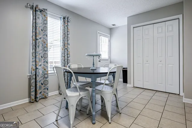 a view of a dining room with furniture and window
