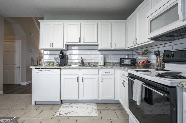 a kitchen with cabinets appliances and a sink