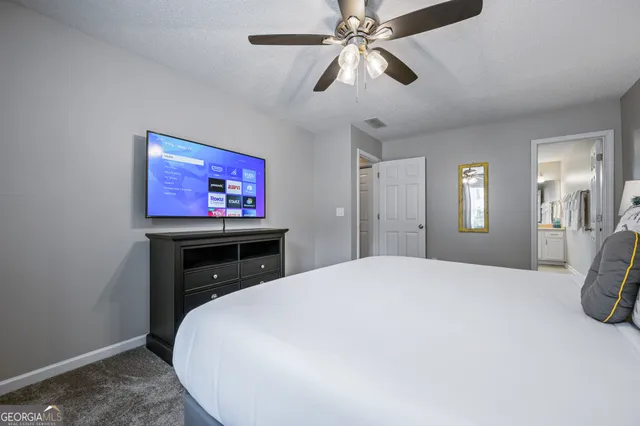 a bedroom with a bed and a flat screen tv
