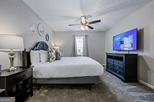 a bedroom with a bed and dresser with mirror