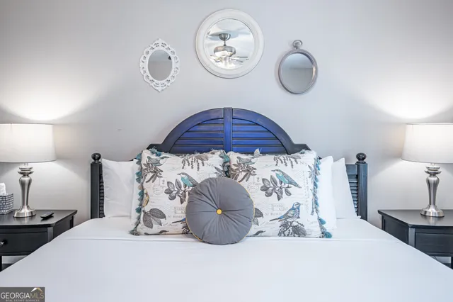 a large bed sitting in a bedroom next to a lamp