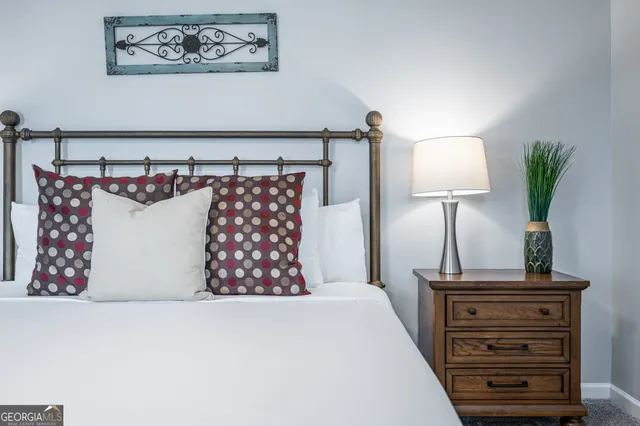 a bed room with a bed and a night stand