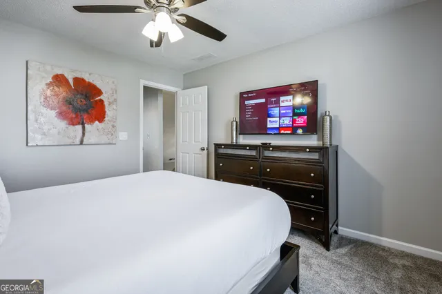 a bedroom with a bed and a flat screen tv