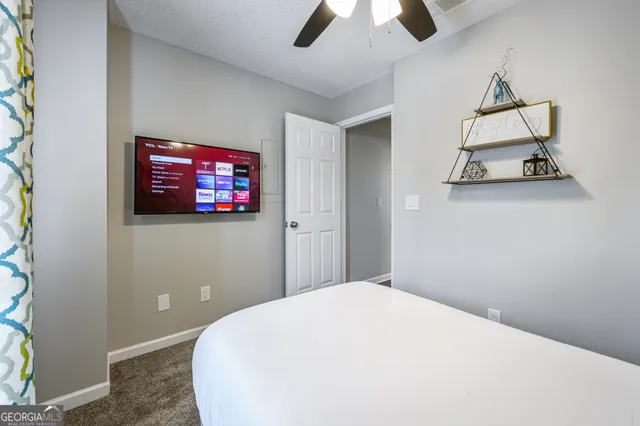 a bedroom with a bed and a flat screen tv