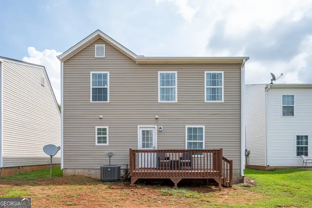 a view of backyard with a deck