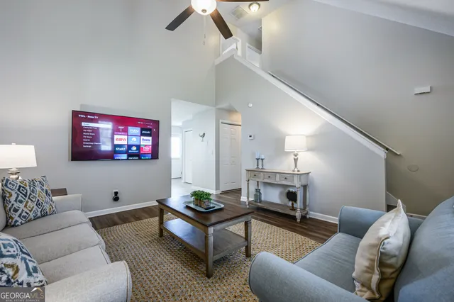 a living room with furniture and a flat screen tv