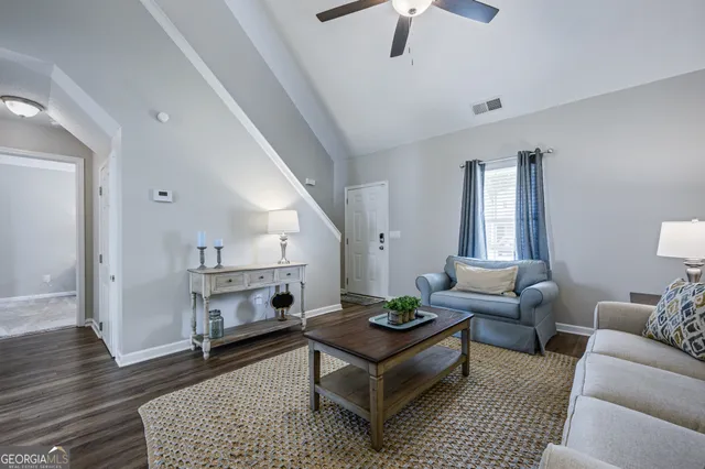 a living room with furniture and a rug