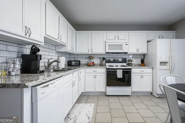 a kitchen with cabinets stainless steel appliances and a sink