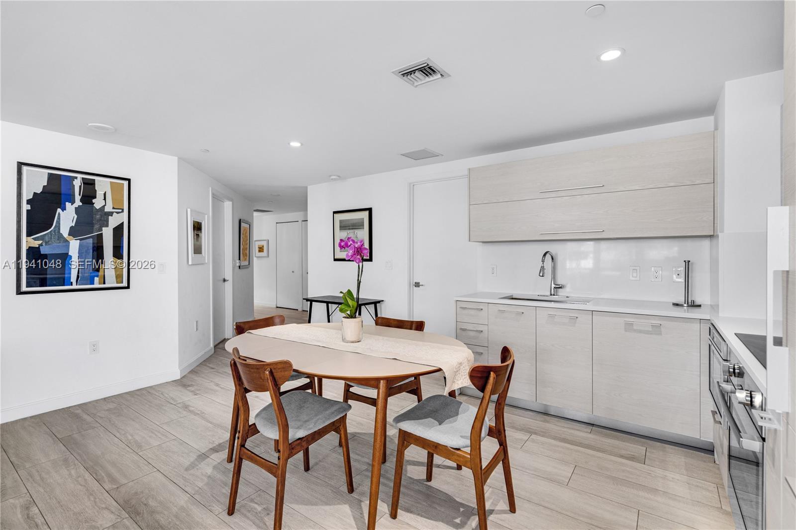 45 Southwest 9th Street, Unit 1001 Miami, FL 33130 - Photo 11 of 40 a view of a dining room with furniture and wooden floor