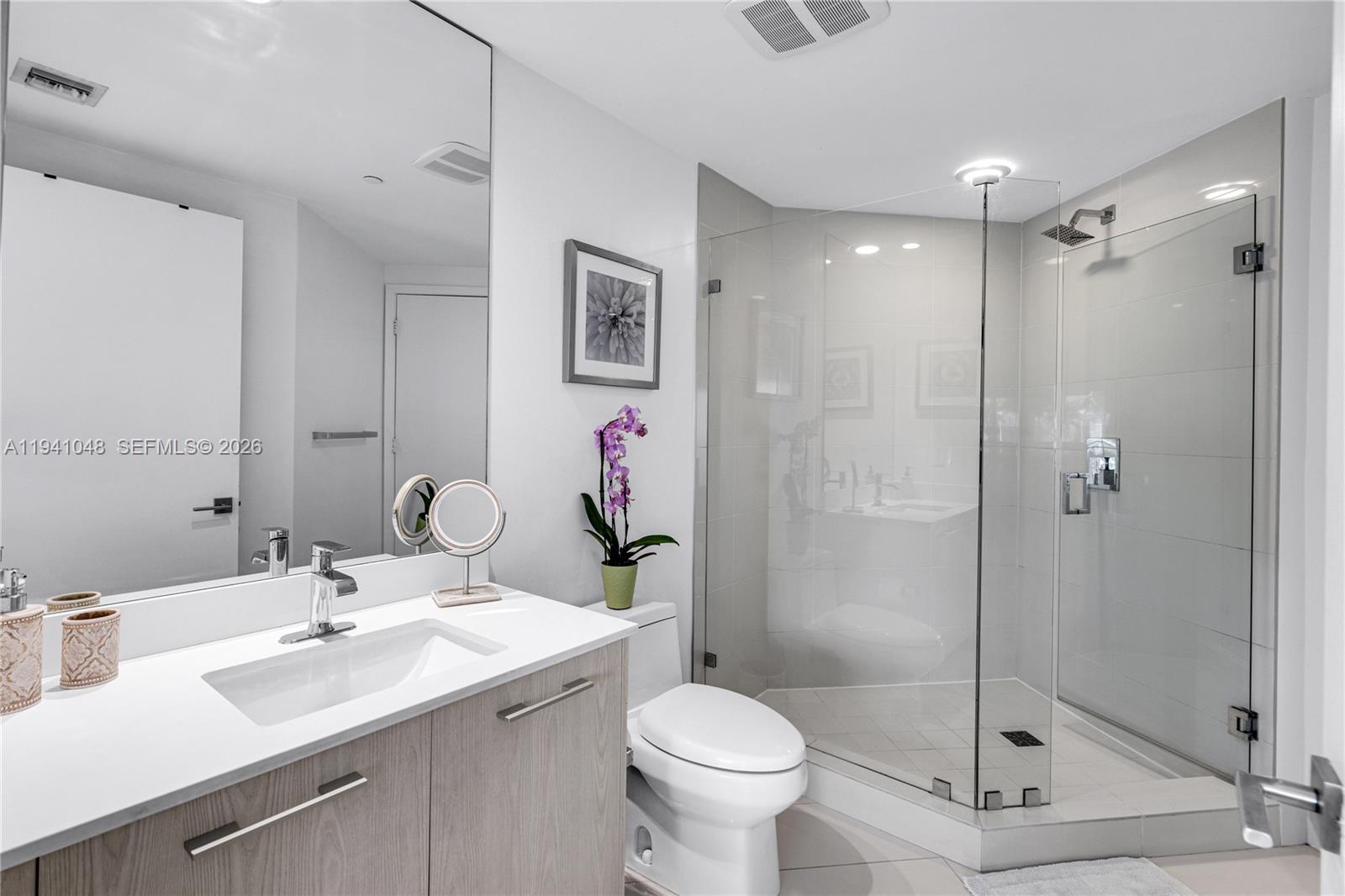 45 Southwest 9th Street, Unit 1001 Miami, FL 33130 - Photo 18 of 40 a bathroom with a sink toilet and shower