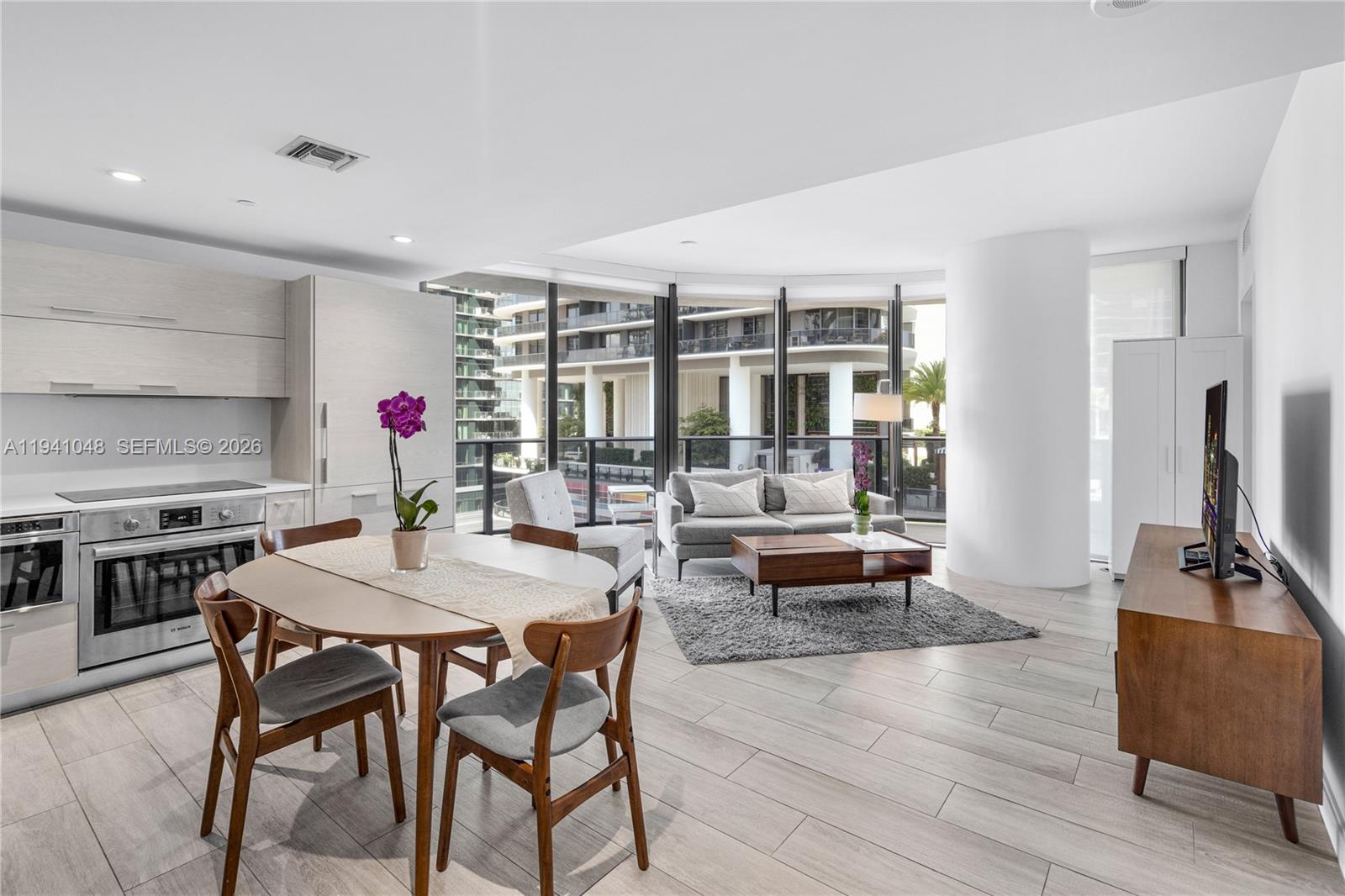 45 Southwest 9th Street, Unit 1001 Miami, FL 33130 - Photo 10 of 40 a view of a dining room with furniture and wooden floor