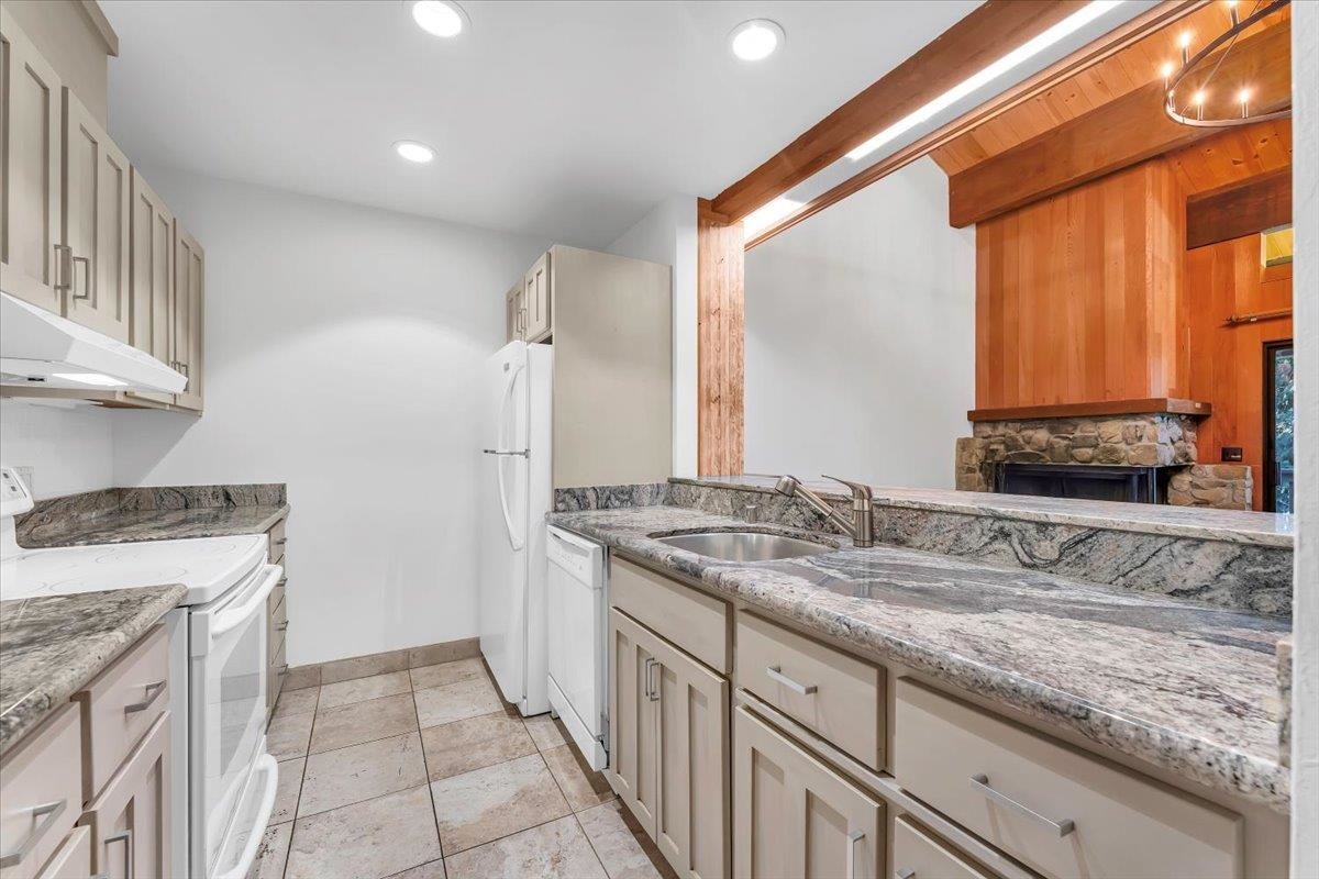 1001 Commonwealth Drive, Unit 49 Kings Beach, CA 96143 - Photo 17 of 25 a bathroom with a granite countertop sink and a mirror