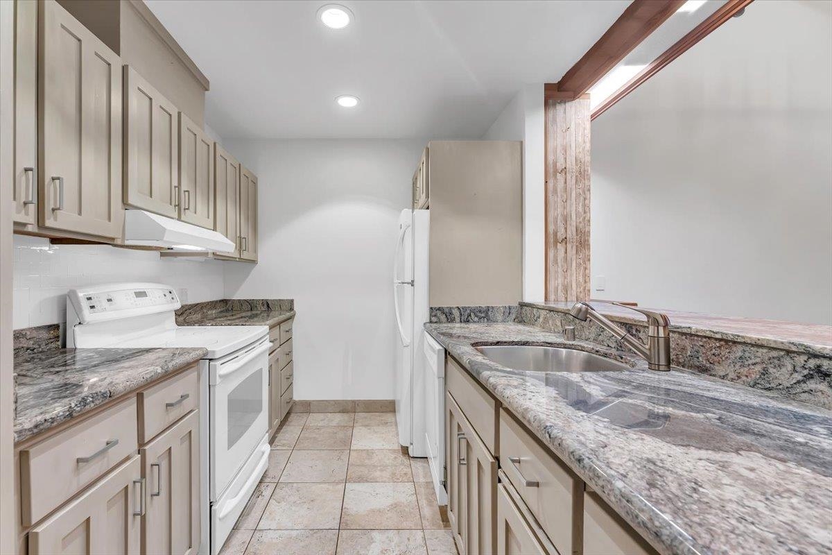 1001 Commonwealth Drive, Unit 49 Kings Beach, CA 96143 - Photo 18 of 25 a kitchen with a sink stove and cabinets