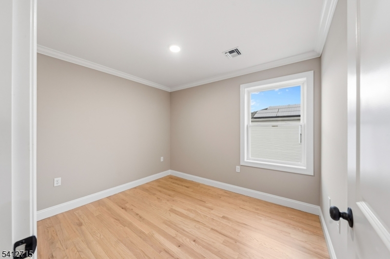 840 Martin Street Elizabeth, NJ 07201 - Photo 13 of 38 a view of empty room with wooden floor and fan