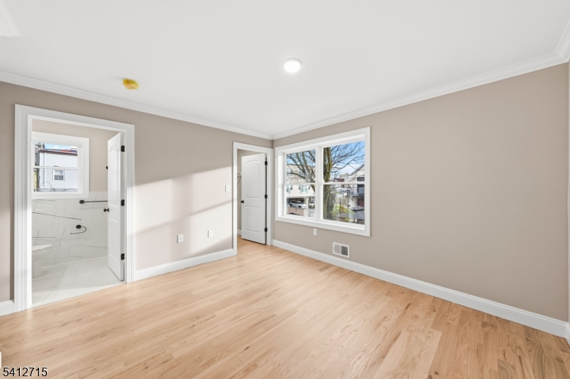 840 Martin Street Elizabeth, NJ 07201 - Photo 16 of 38 a view of an empty room with wooden floor and a window