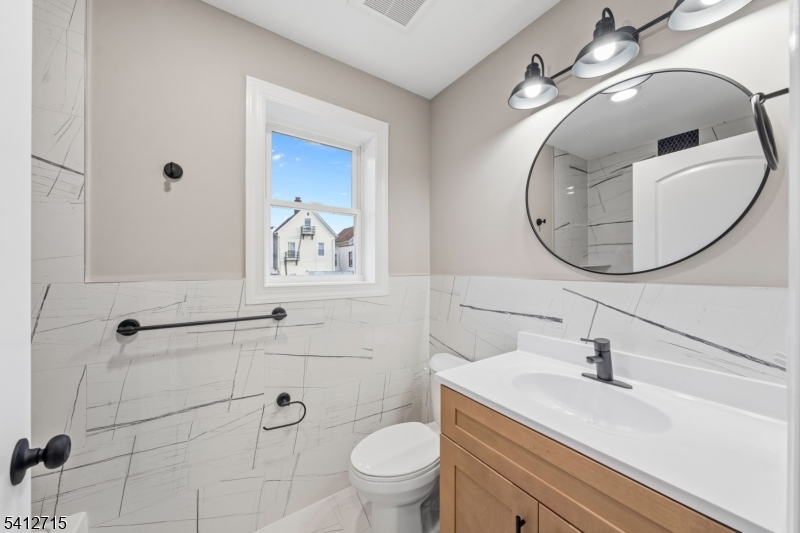 840 Martin Street Elizabeth, NJ 07201 - Photo 19 of 38 a bathroom with a sink a toilet and a mirror