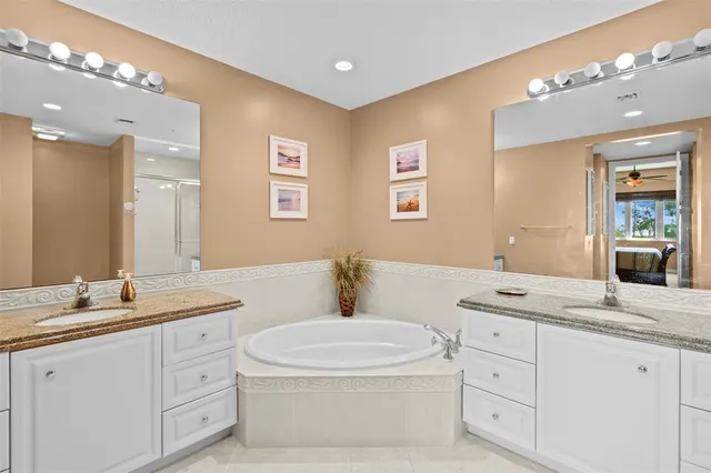 a bathroom with a granite countertop sink mirror and toilet