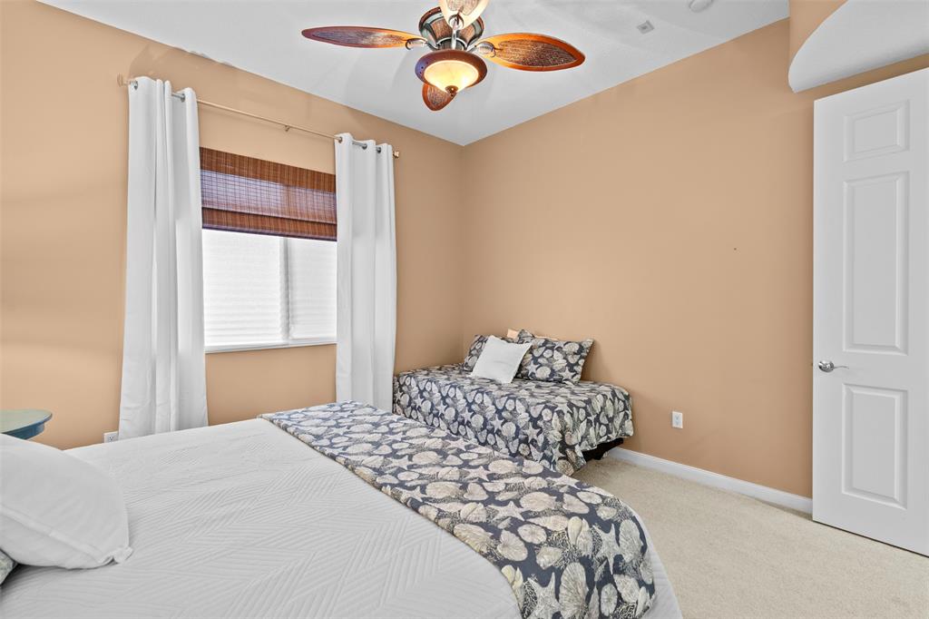 23 Harbour Isle Drive West, Unit 102 Fort Pierce, FL 34949 - Photo 22 of 40 a bedroom with a bed and a window