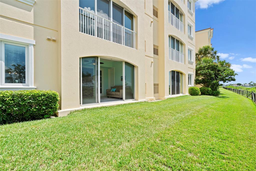 23 Harbour Isle Drive West, Unit 102 Fort Pierce, FL 34949 - Photo 28 of 40 a view of a building with a garden