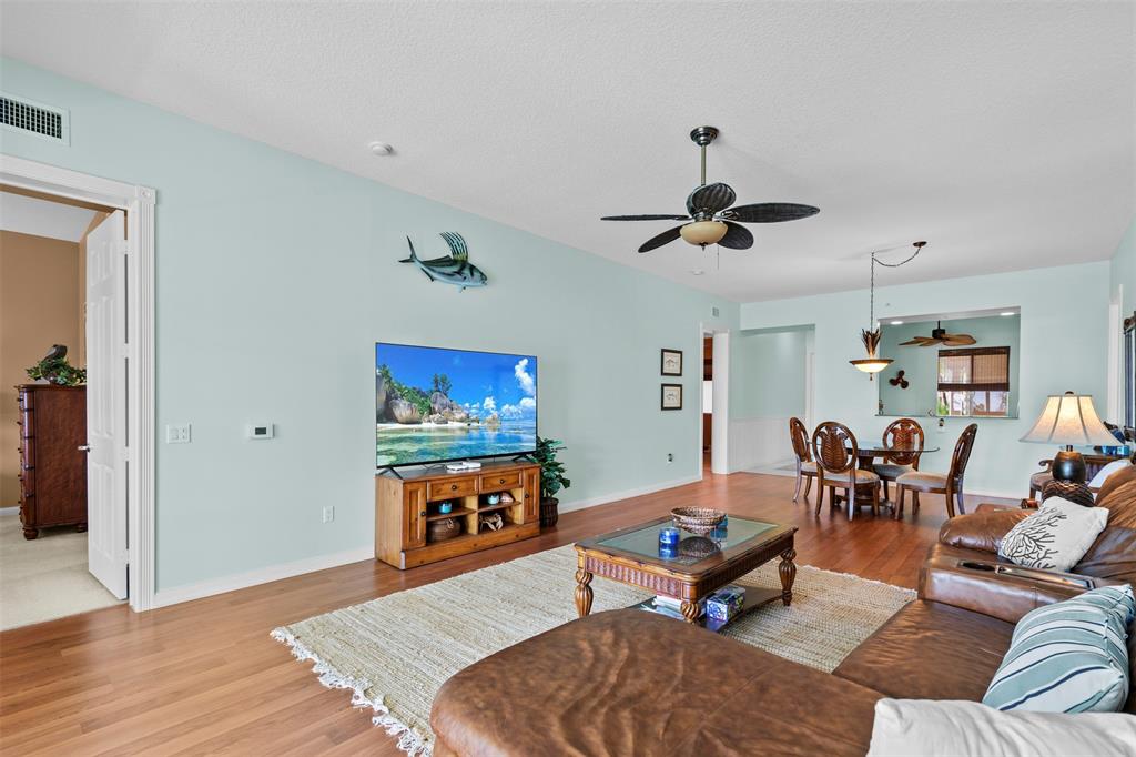 23 Harbour Isle Drive West, Unit 102 Fort Pierce, FL 34949 - Photo 8 of 40 a living room with furniture kitchen view and a chandelier