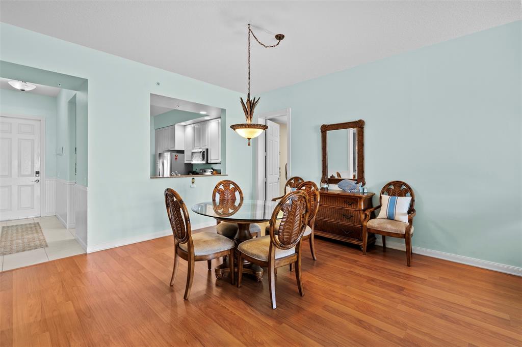 23 Harbour Isle Drive West, Unit 102 Fort Pierce, FL 34949 - Photo 9 of 40 a dining room with furniture and wooden floor